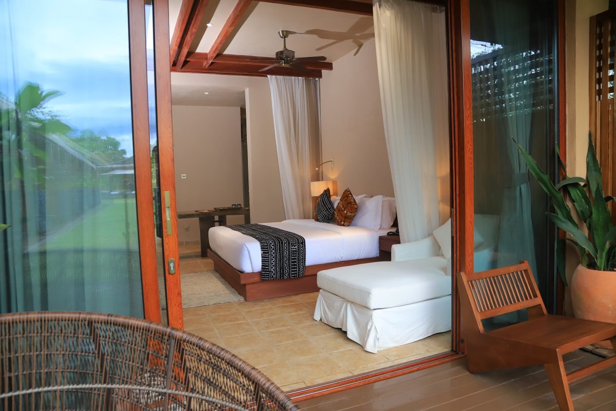 African-styled double room with glass frontage and private veranda at Entikko