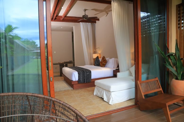 African-styled double room with glass frontage and private veranda at Entikko