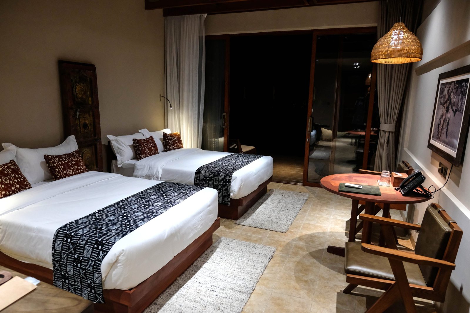 Twin beds setup inside Entikko Safari Lodge room for 2 adults and a child