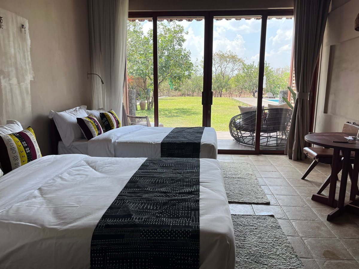 Spacious twin room at Entikko Safari Lodge with two beds and nature view