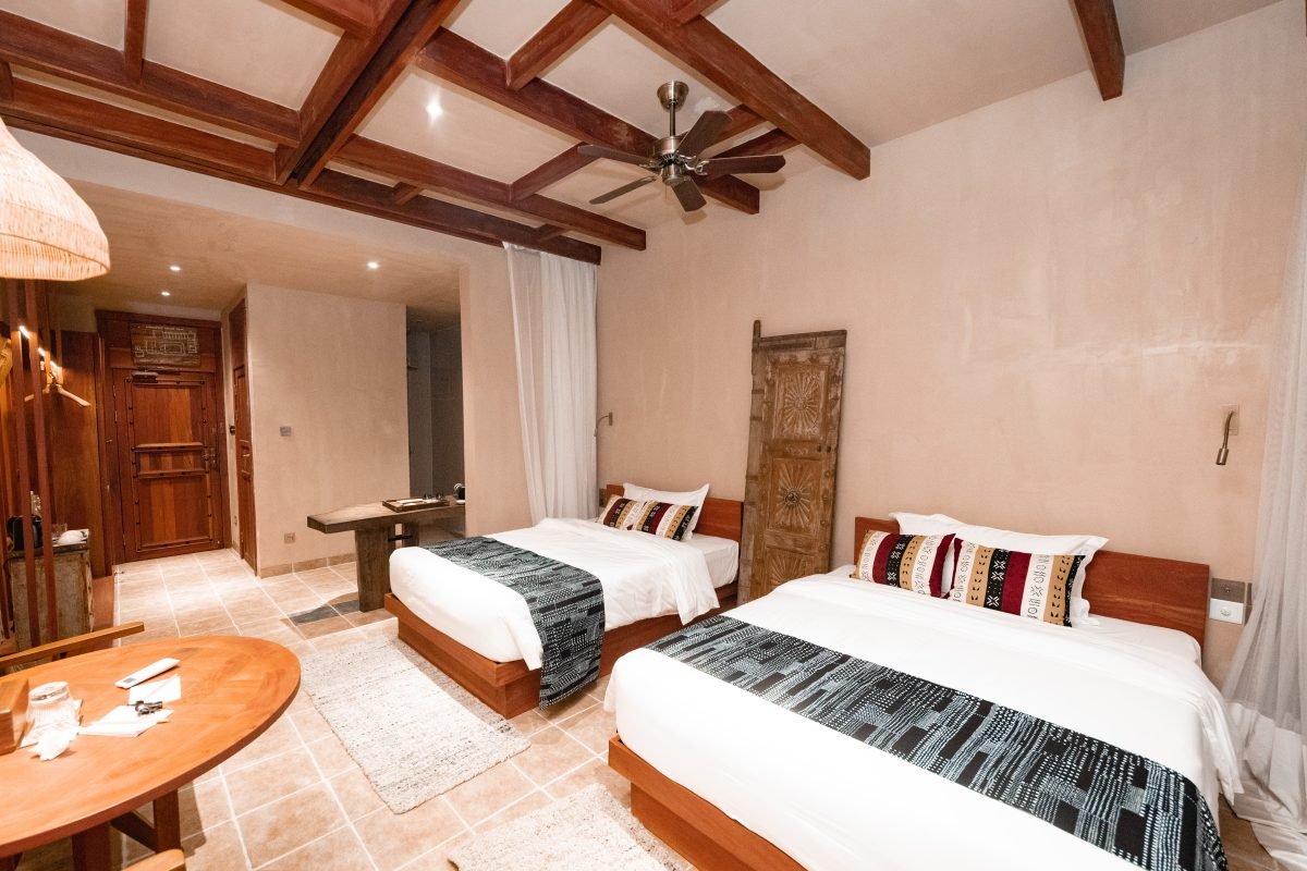 Comfortable twin room with outdoor view and African-style decor at Entikko