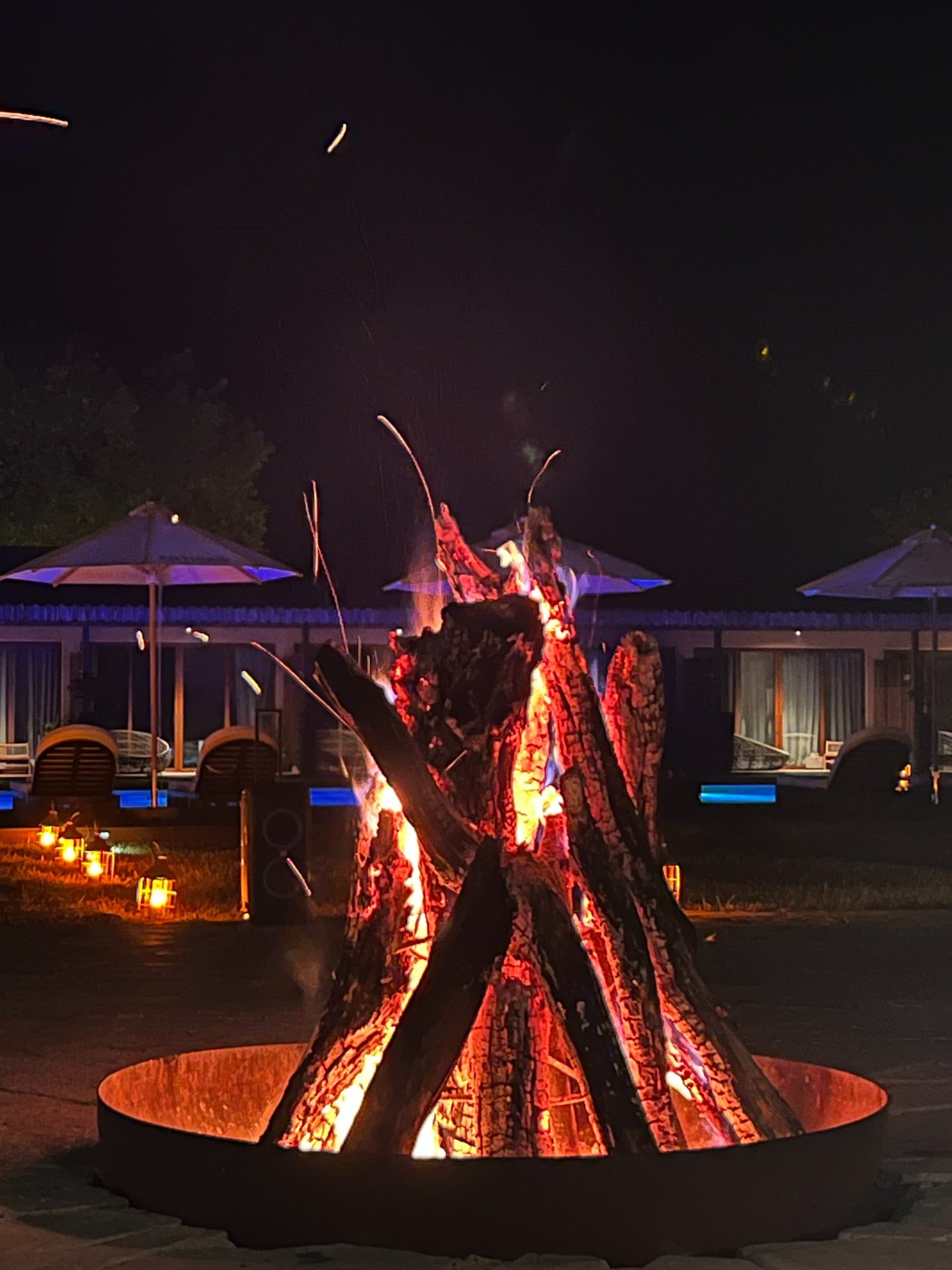 Guests relaxing around a bonfire at Entikko Safari Lodge