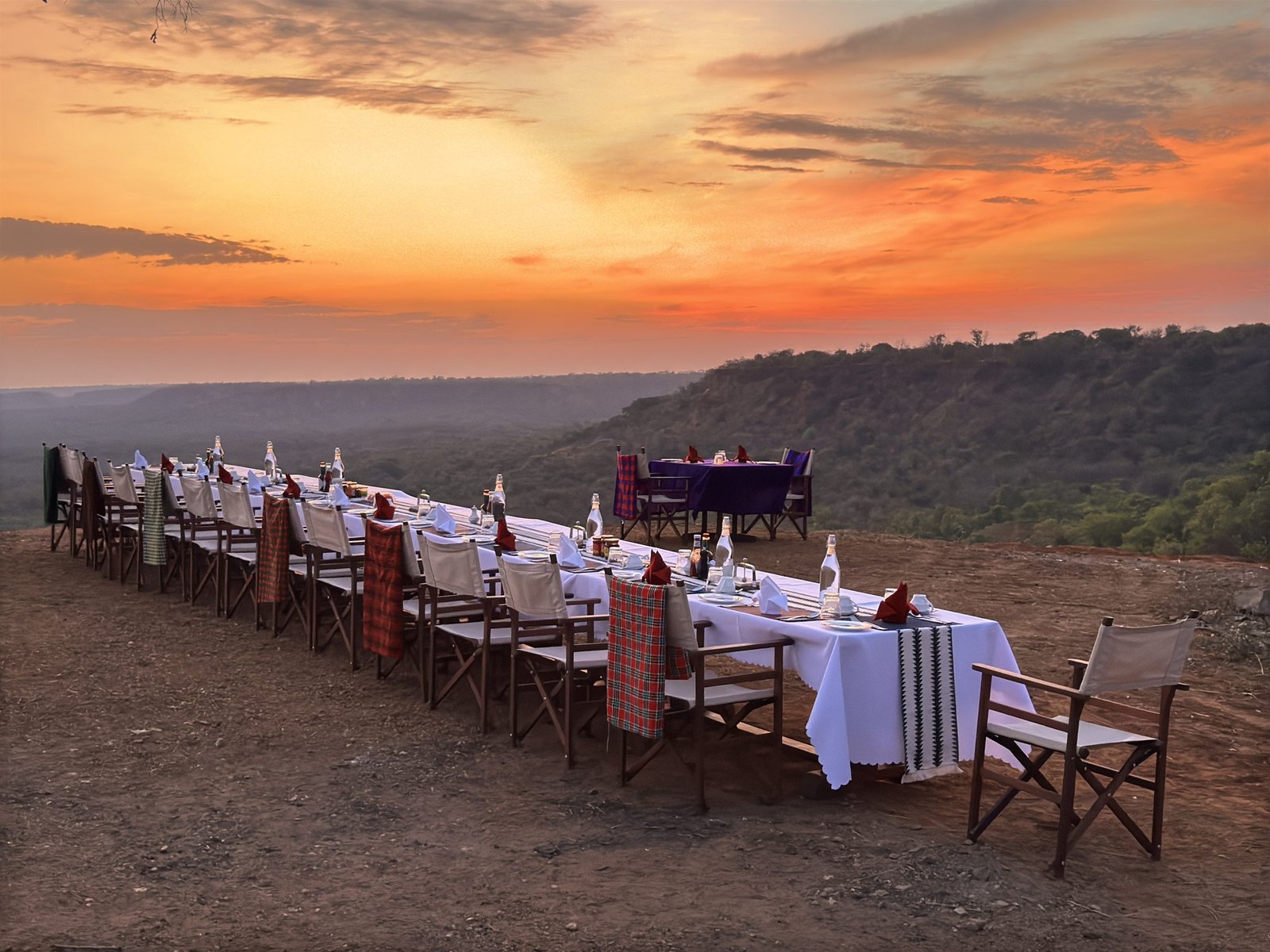 Outdoor dinner setup for a group at Entikko Safari Lodge under the stars