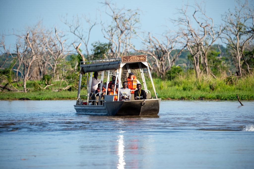 Guests on a boat safari at Entikko Safari Lodge viewing wildlife on the water