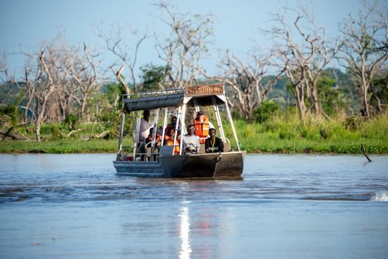 Guests on a boat safari at Entikko Safari Lodge viewing wildlife on the water