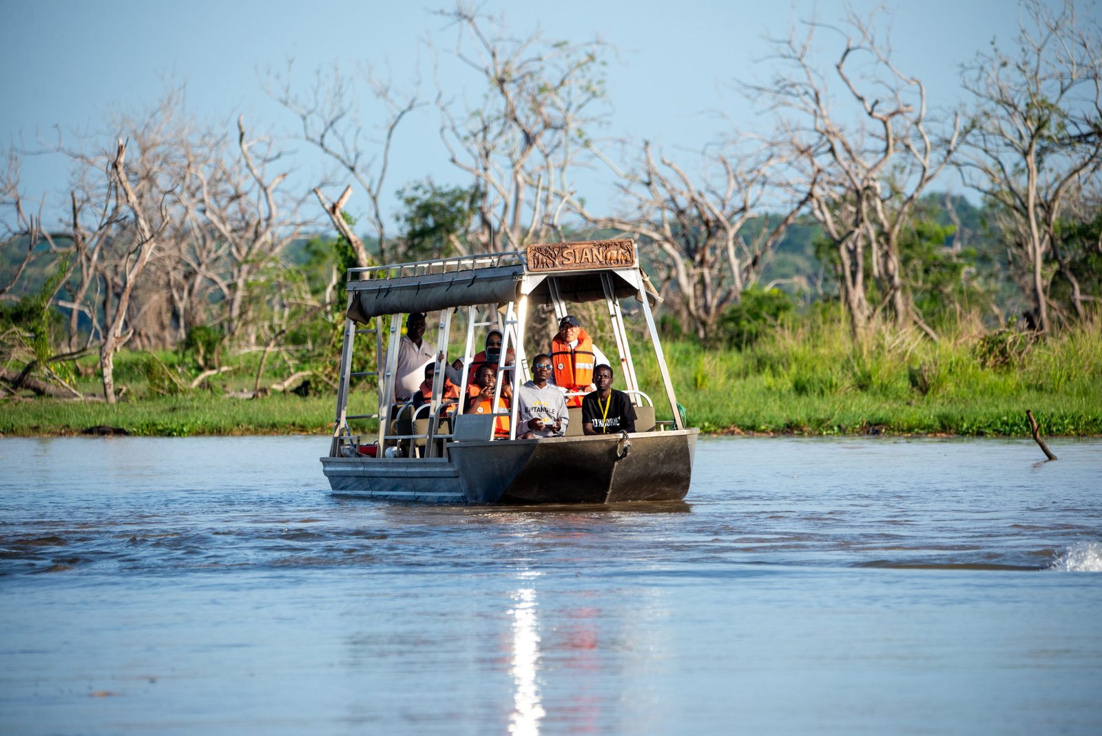 Guests on a boat safari at Entikko Safari Lodge viewing wildlife on the water