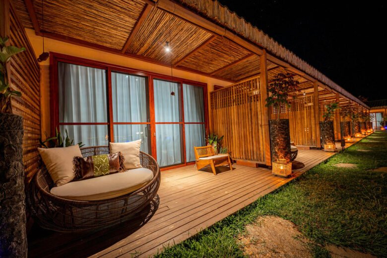 Luxury outdoor terrace with ambient lighting and lush greenery at Entikko Safari Lodge Uganda near Murchison Falls