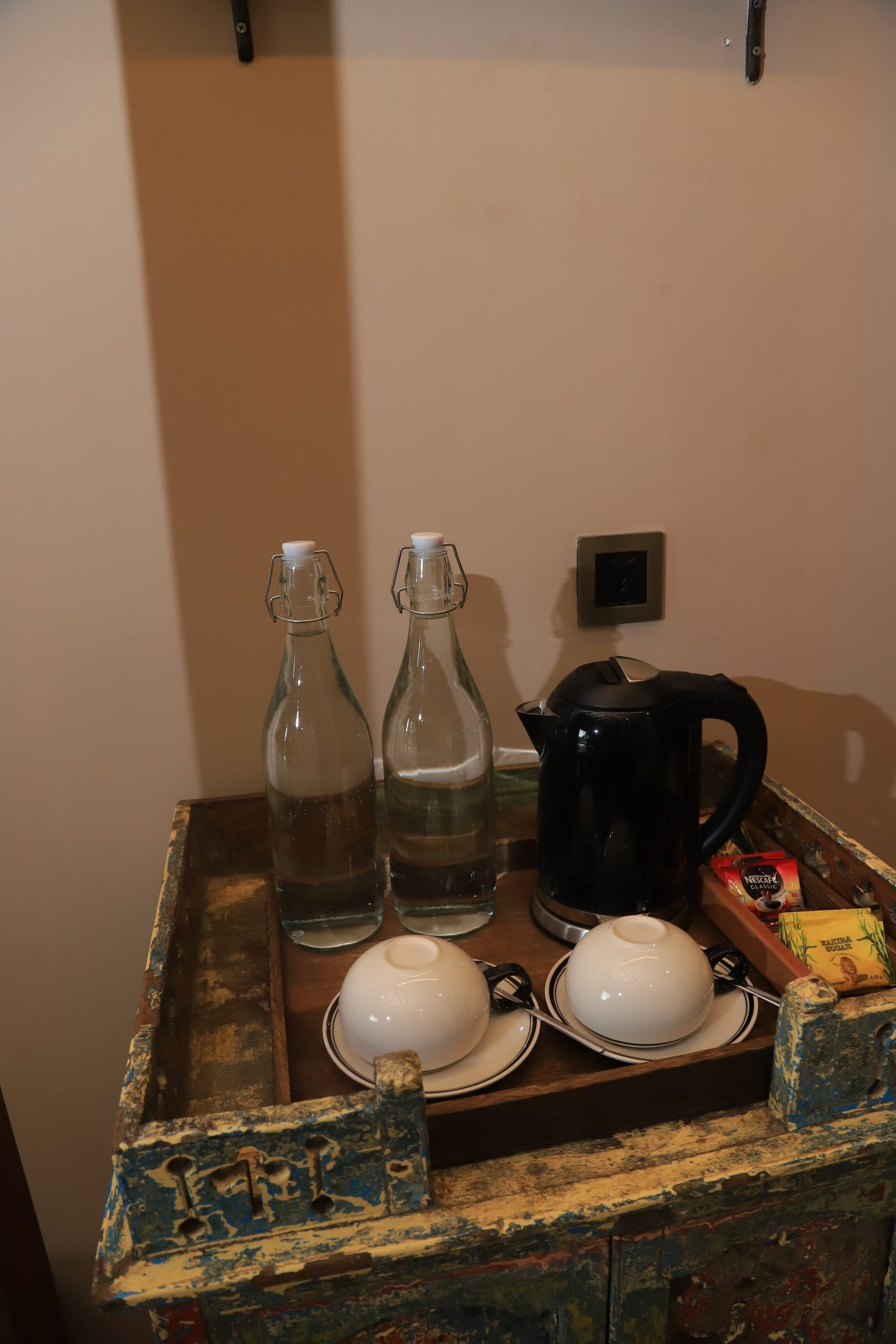 Cup of tea with parcolator water heater on hospitality tray in Entikko Safari Lodge single room