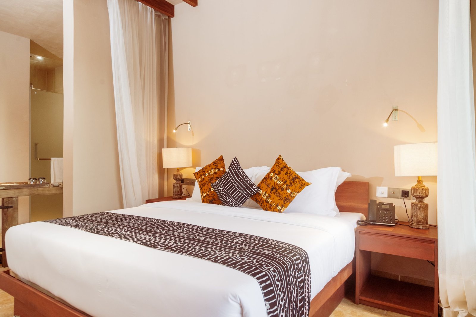 Single room at Entikko Safari Lodge with cozy bed and nature view