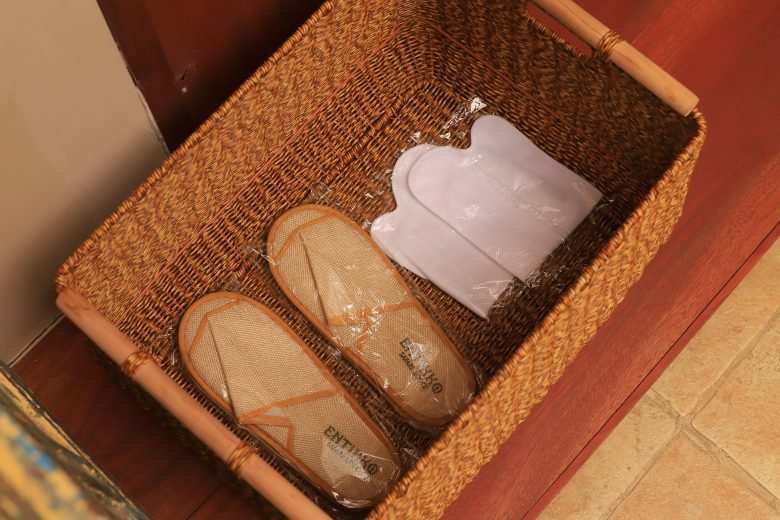 Guest slippers amenities neatly arranged on floor mat in Entikko Safari Lodge single room
