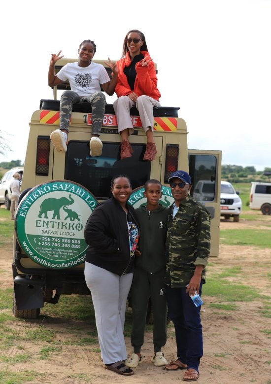 Family posing for a photo during a safari game drive at Entikko Safari Lodge in Uganda