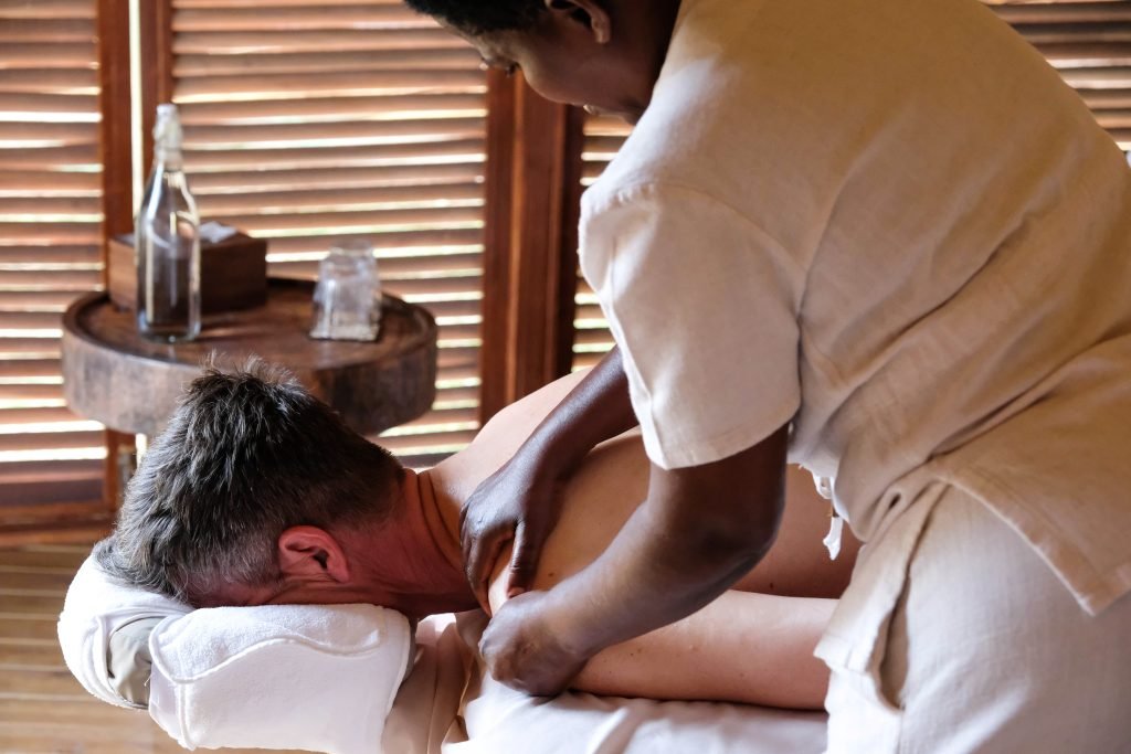 Guest receiving a relaxing spa massage at Entikko Safari Lodge in Uganda