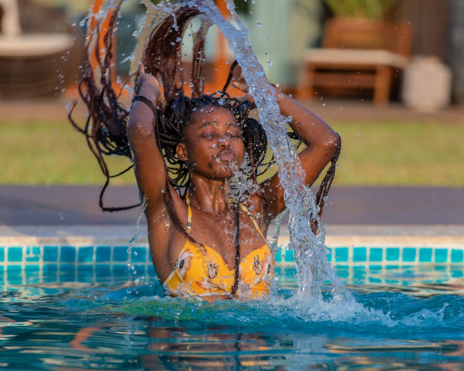 Guest enjoying a swim in the outdoor pool at Entikko Safari Lodge