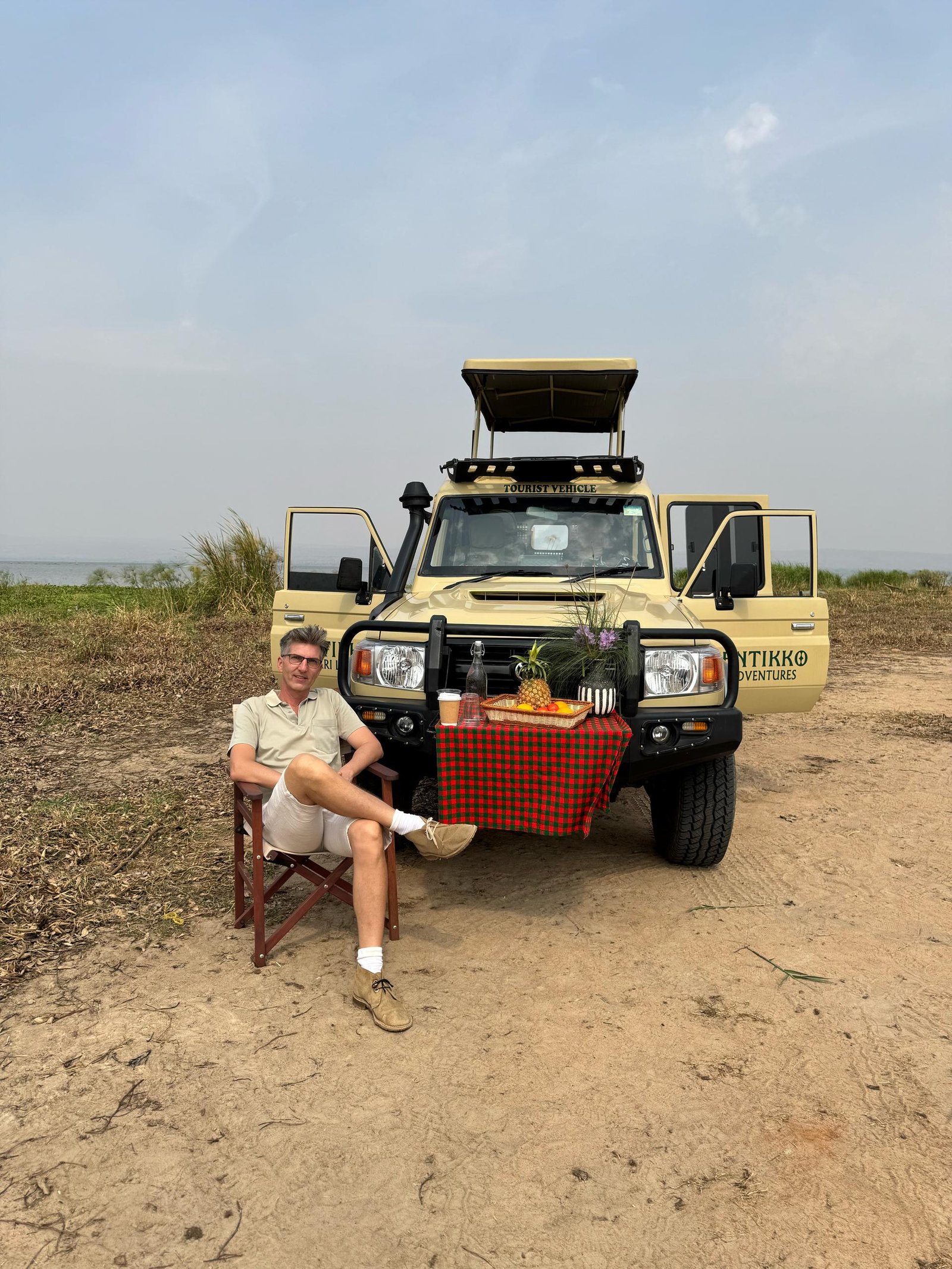 This image highlights the immersive experience of a guided game drive with Entikko Safari Lodge where guests get to relax and witness Uganda’s wildlife up close from open-roof vehicles.