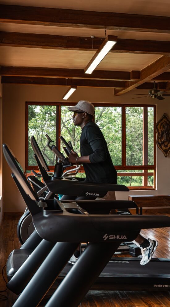 Guest working out in the fully equipped gym at Entikko Safari Lodge, Uganda