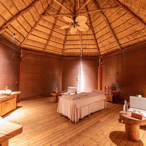 Luxury spa and massage suite with thatched roof and ambient lighting at Entikko Safari Lodge near Murchison Falls Uganda